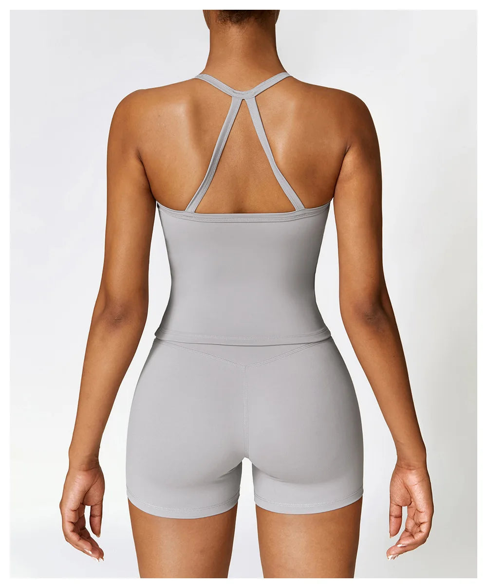 Back view of woman wearing a gray breathable gym workout bra for women with matching shorts