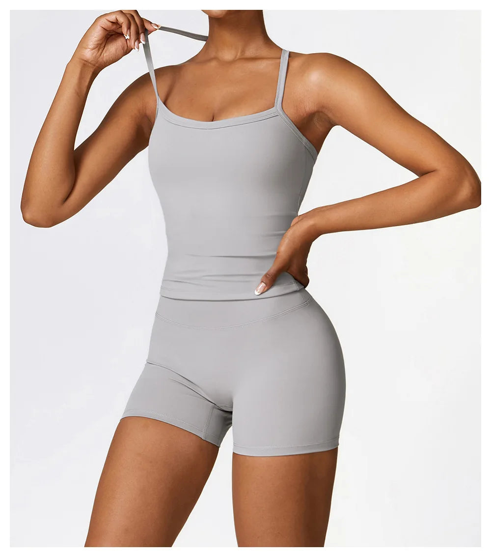 KiKis breathable gym workout bra for women in light gray with adjustable straps worn with matching shorts