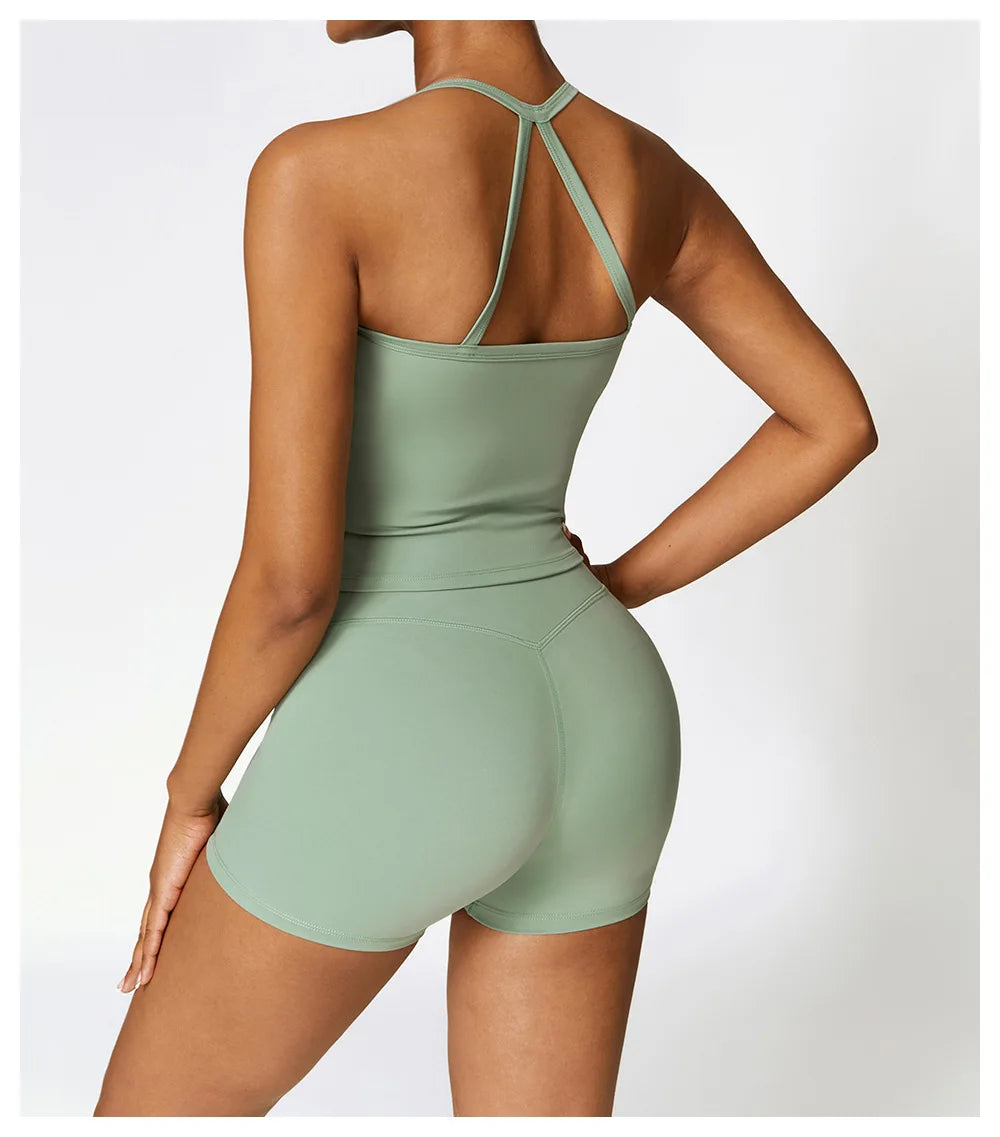 Back view of woman wearing sage green breathable gym workout bra for women with matching shorts