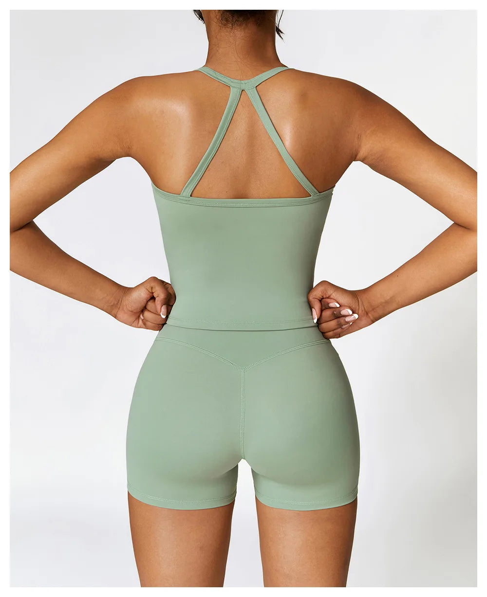 Back view of a woman wearing a breathable gym workout bra for women by KiKis in light green