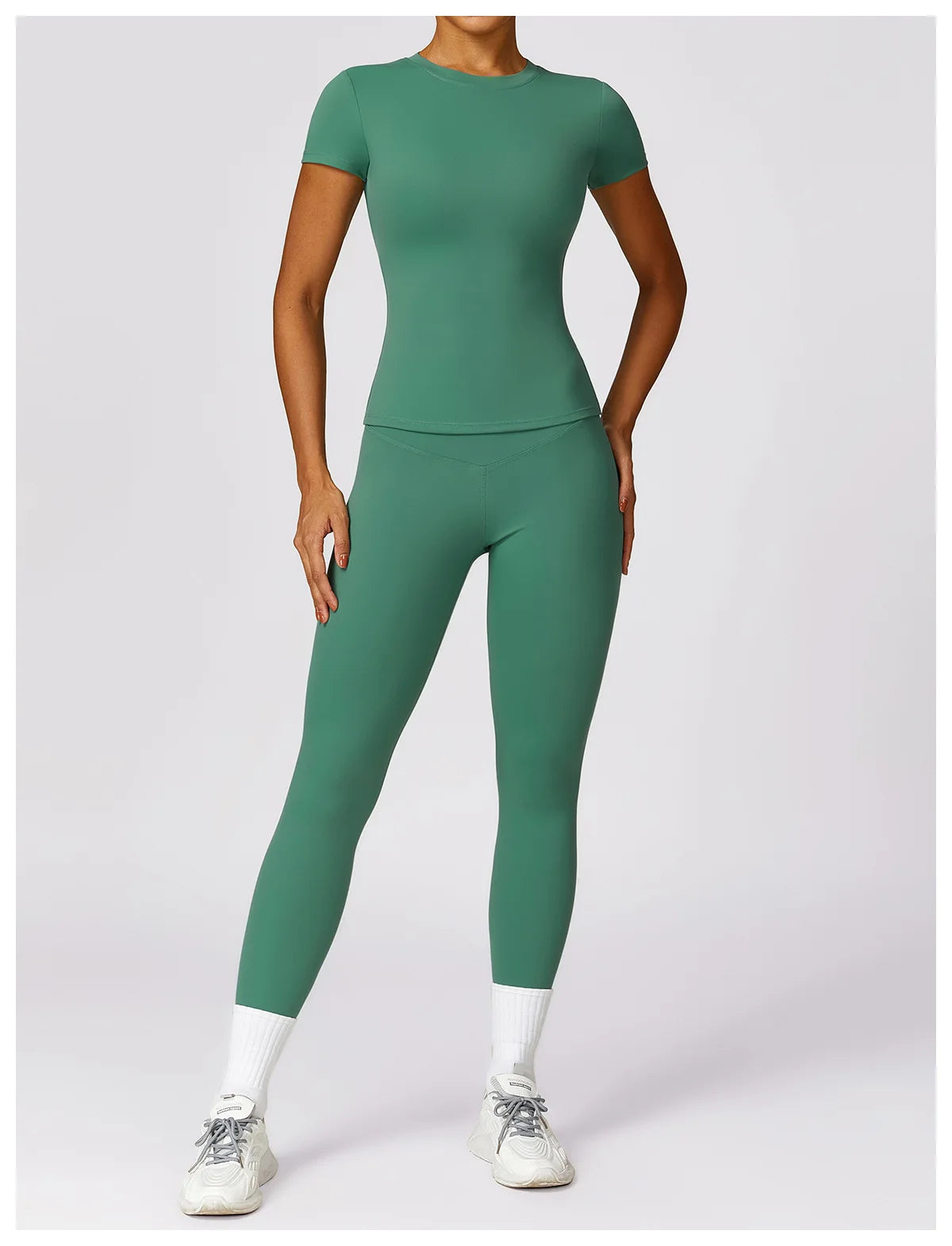 KiKis seamless yoga top for women in green with matching leggings worn by model