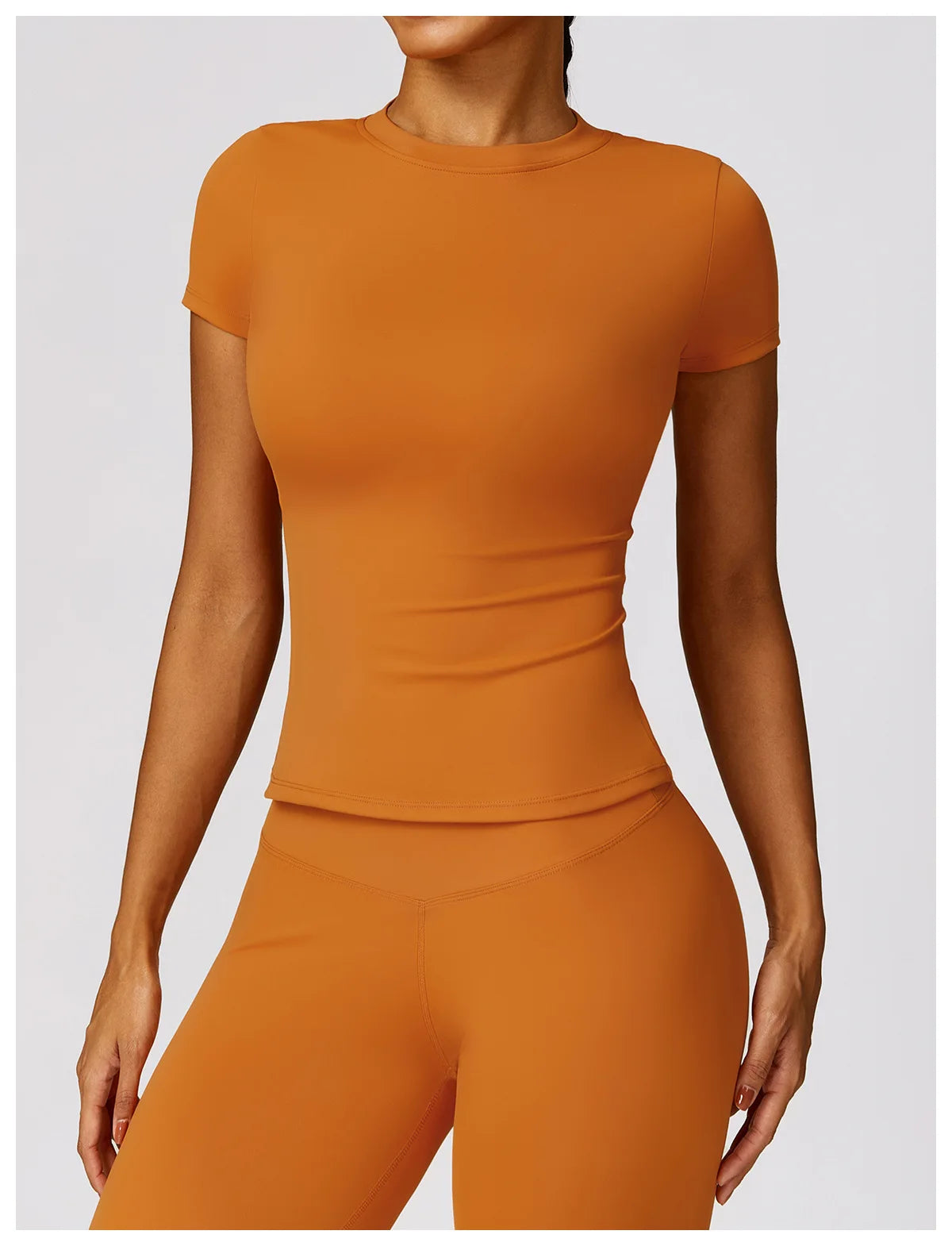 KiKis seamless yoga top for women in orange with short sleeves and fitted design