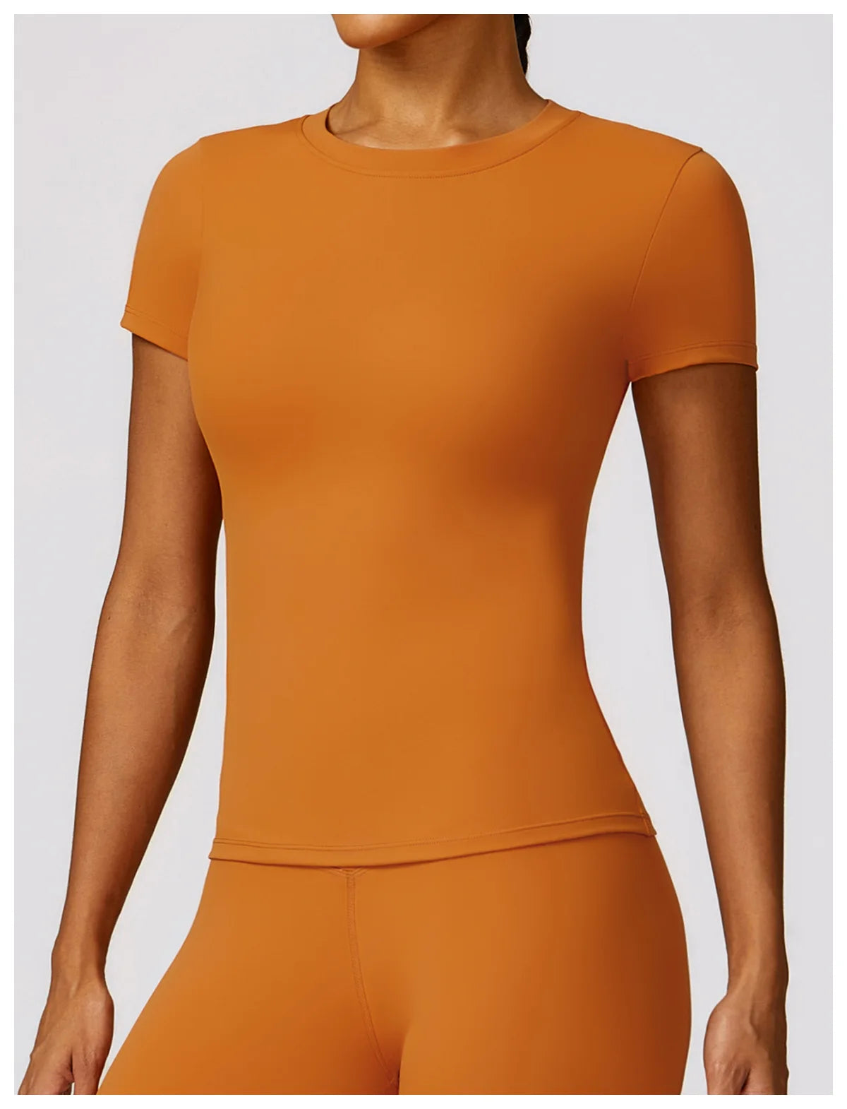 KiKis seamless yoga top for women in burnt orange with short sleeves and fitted design