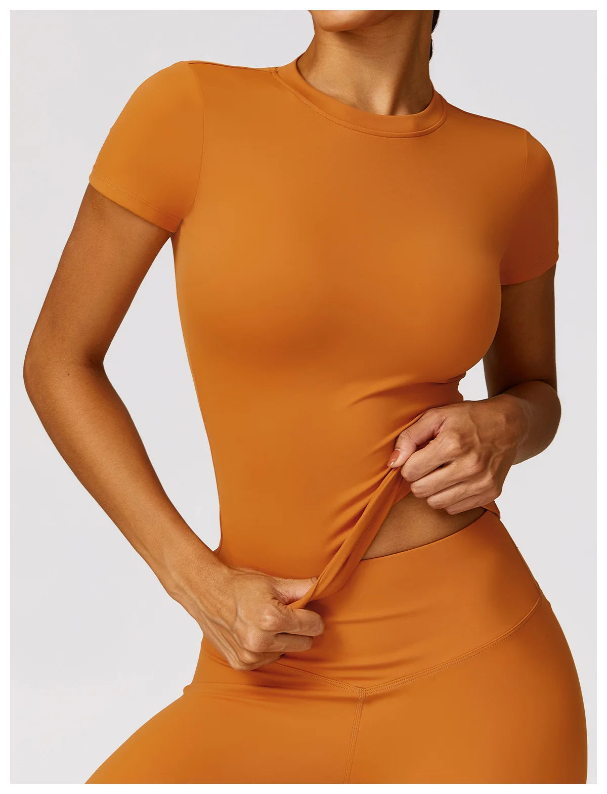 KiKis seamless yoga top for women in orange with short sleeves and stretchy fabric