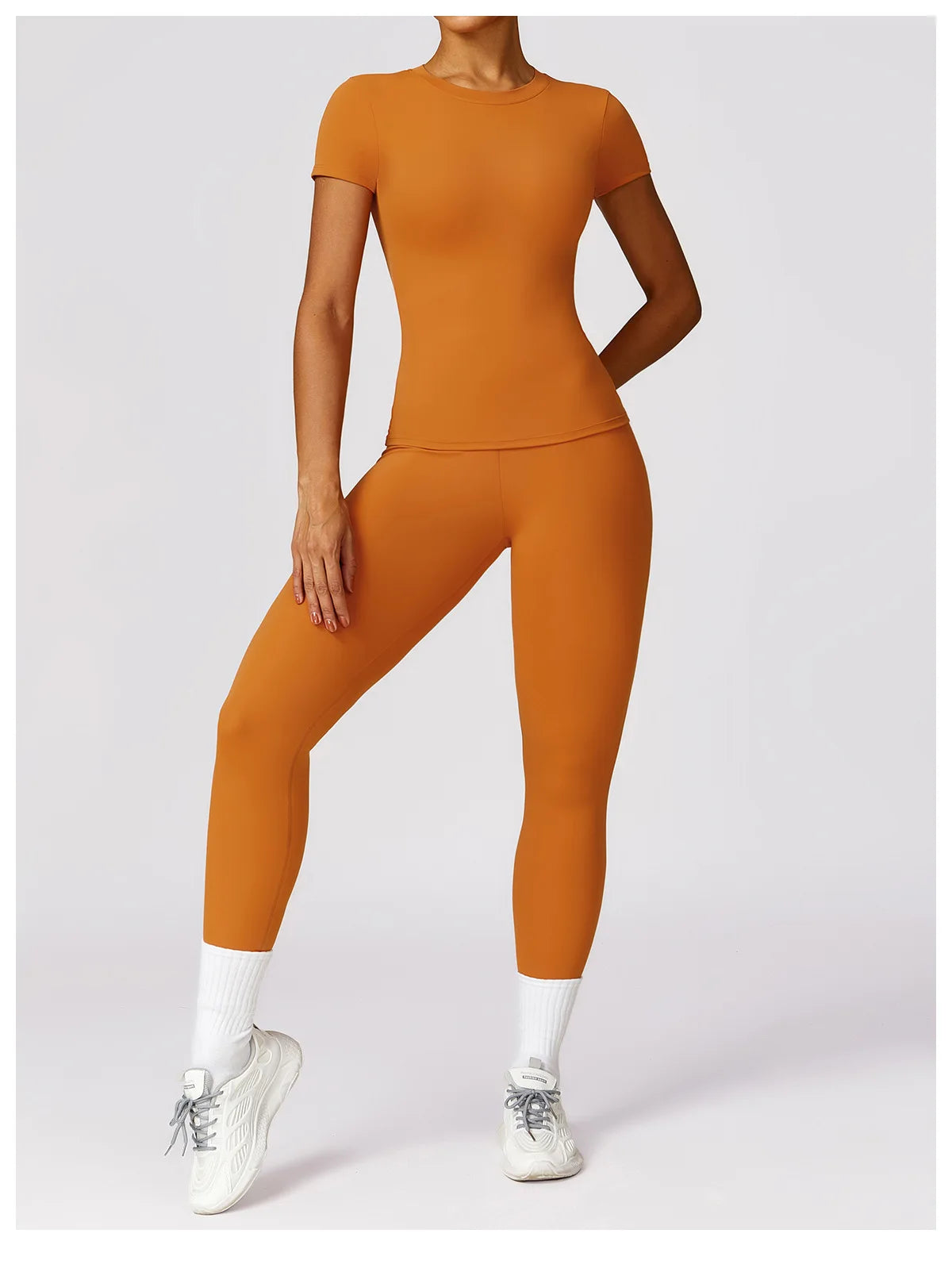 KiKis seamless yoga top for women in burnt orange paired with matching leggings and white sneakers