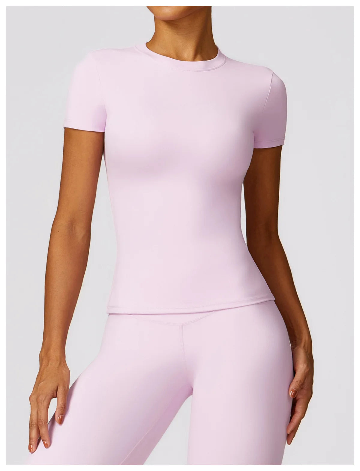 KiKis light pink seamless yoga top for women with short sleeves and fitted design