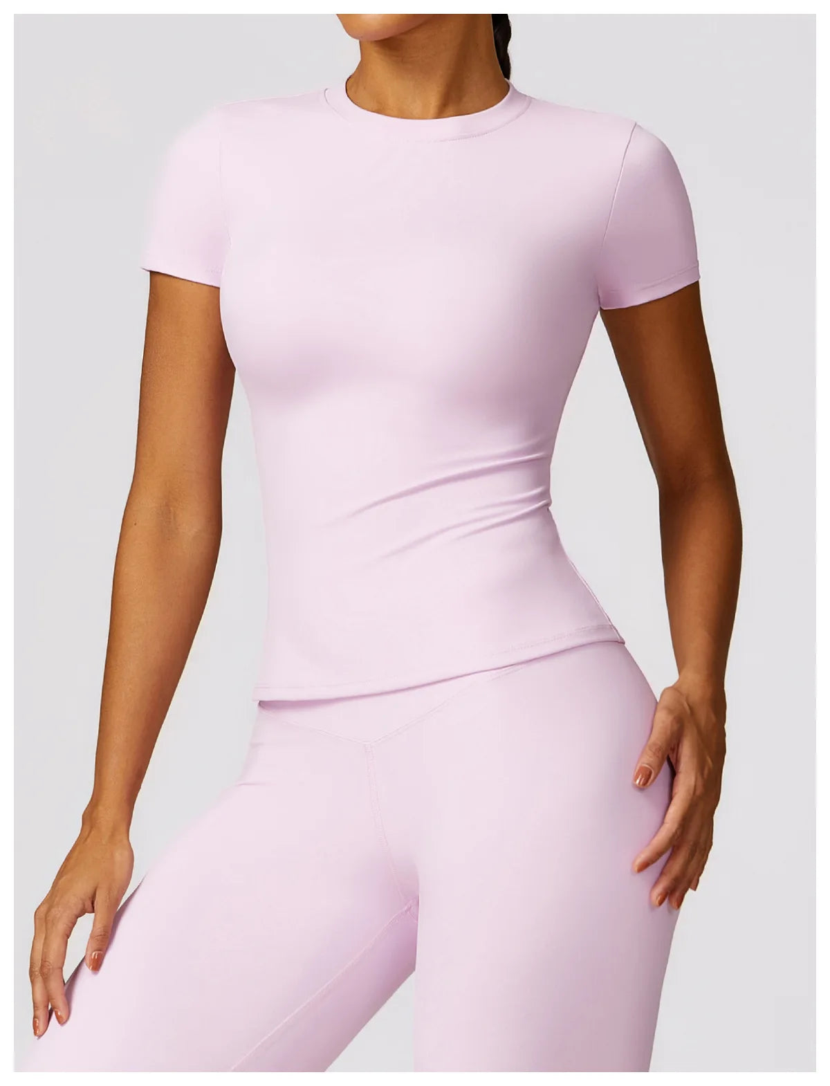 KiKis seamless yoga top for women in light pink with short sleeves and fitted design