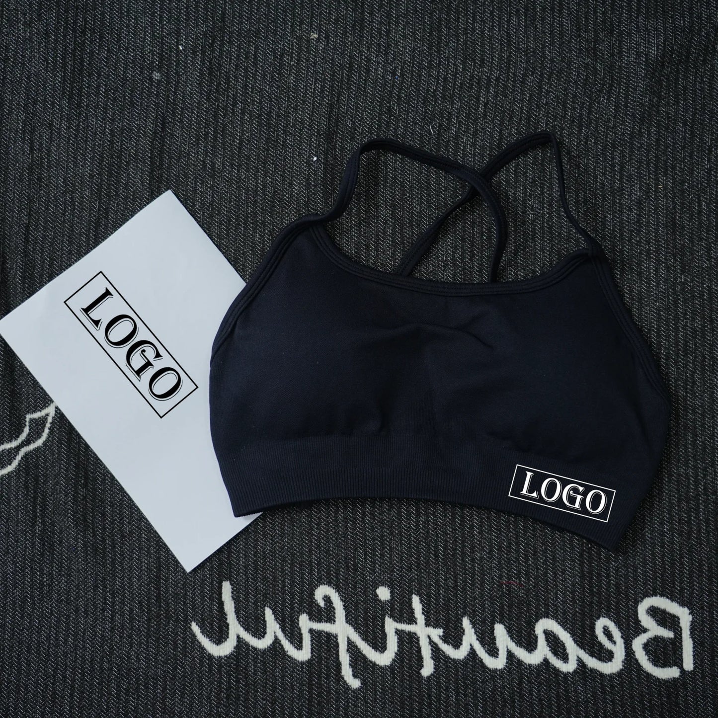 KiKis black women's seamless sports bra with cross back straps and logo detail
