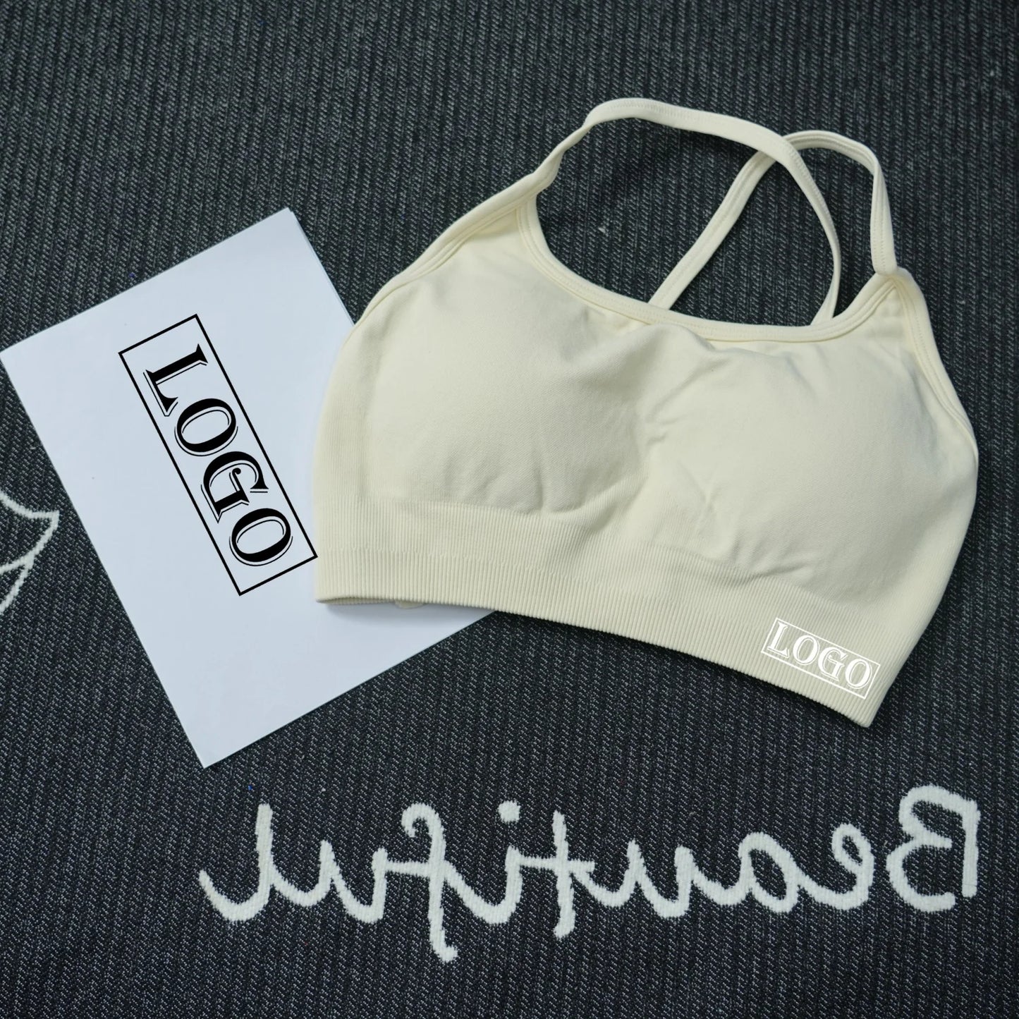 KiKis women's seamless sports bra in beige with thin straps on dark textured background