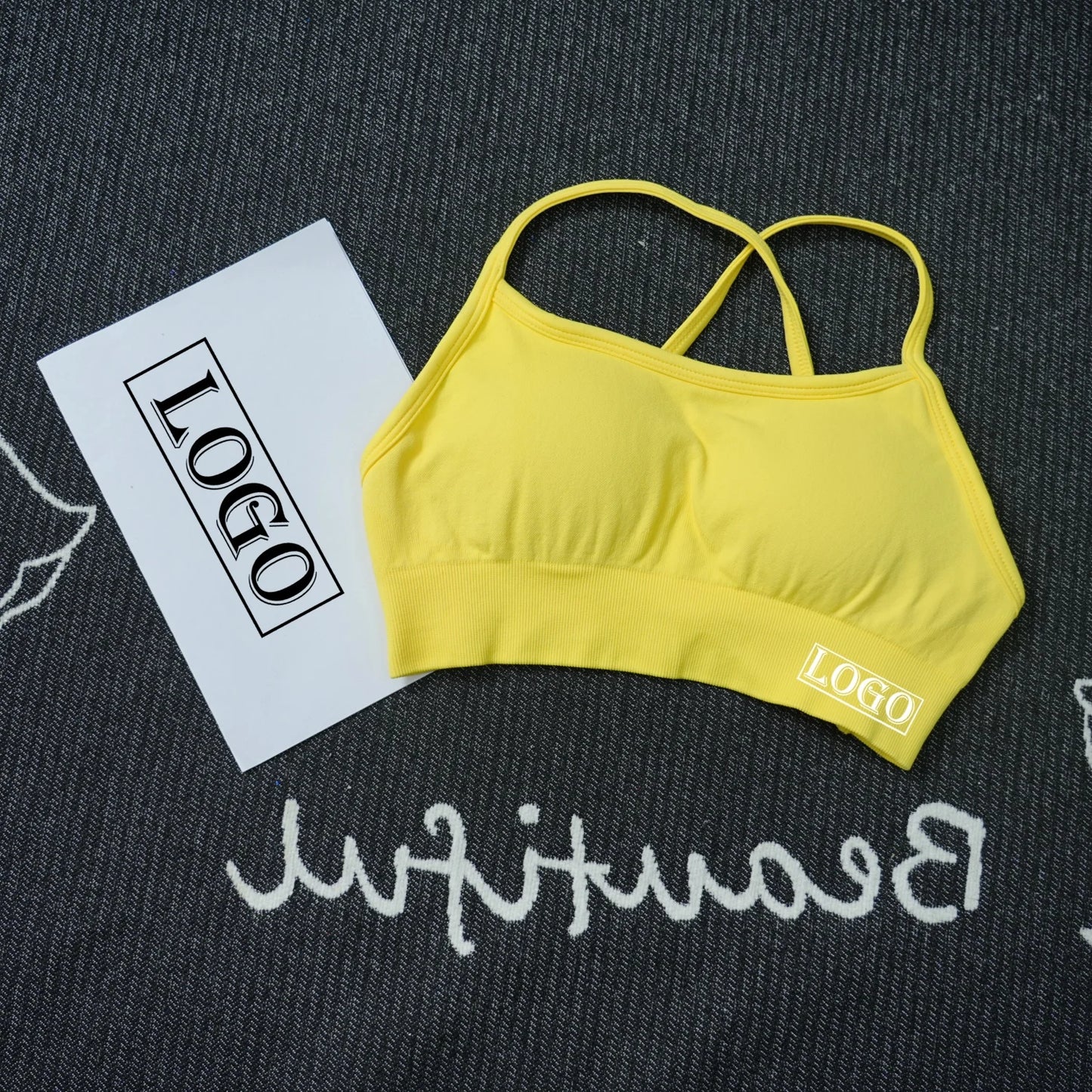 KiKis women's seamless sports bra in yellow with thin straps and logo on fabric