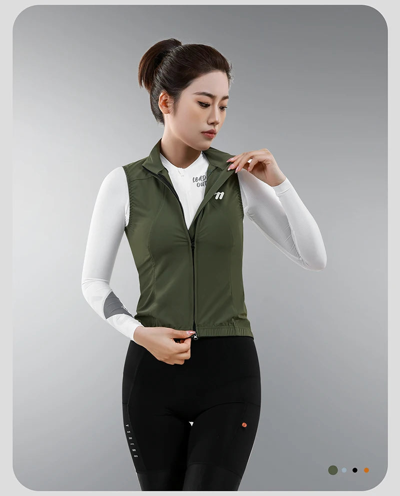 KiKis women's cycling vest summer in olive green worn by woman with white long sleeve shirt and black cycling pants