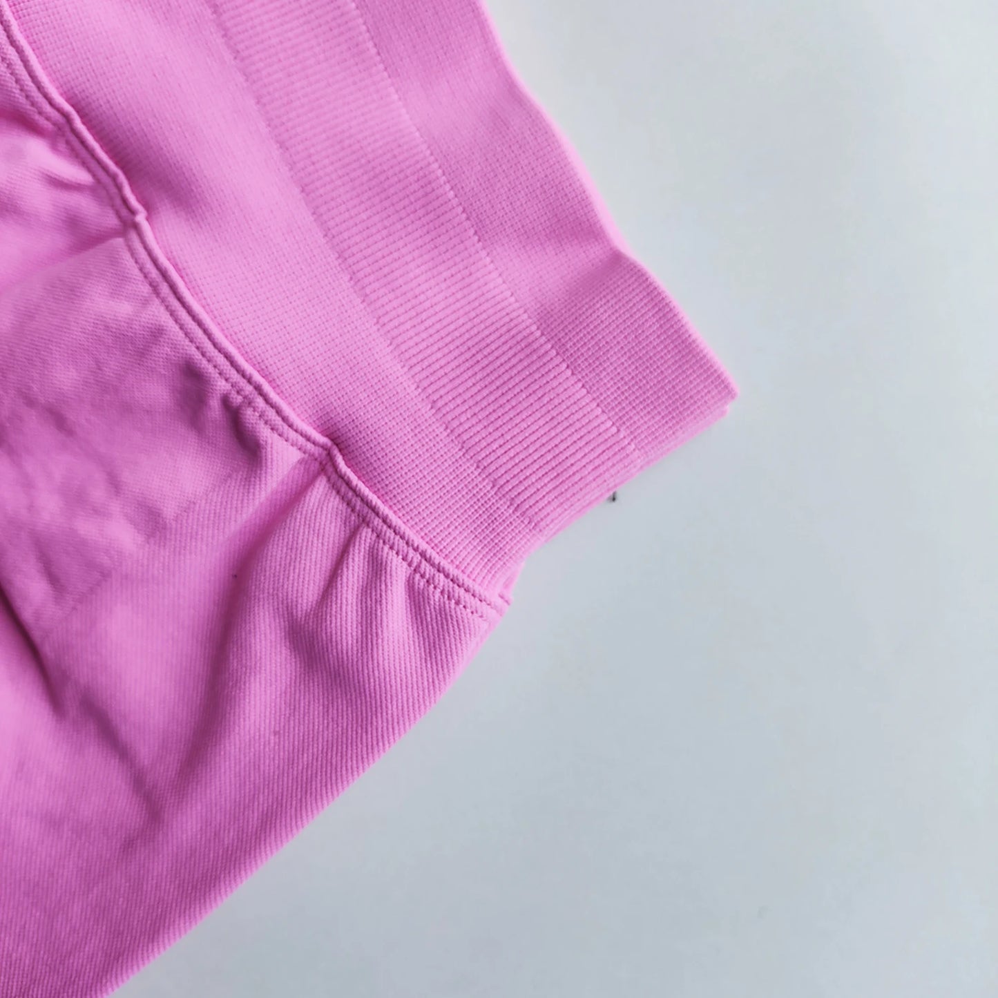 Close-up of pink Woman Scrunch Bum Flare Leggings showing scrunched detail and stitching