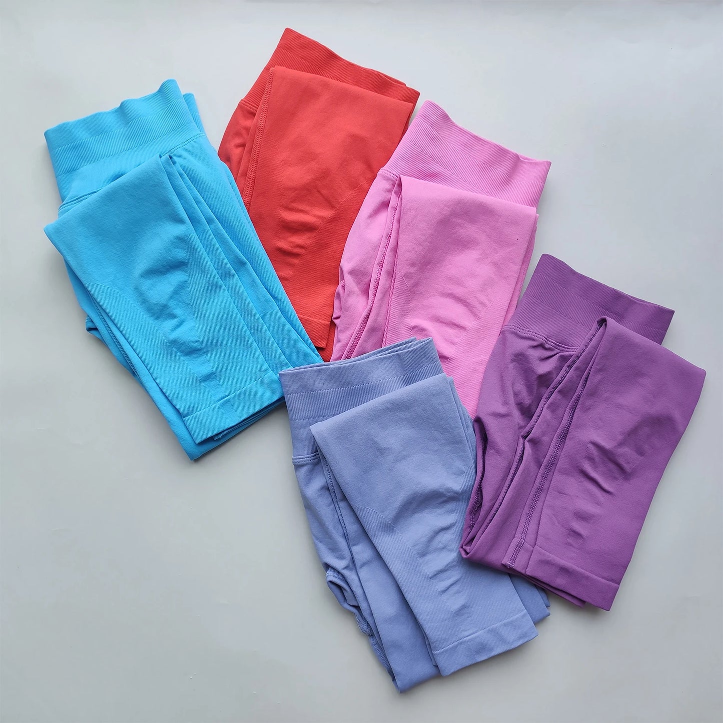 KiKis Woman Scrunch Bum Flare Leggings in various colors including blue pink purple and red