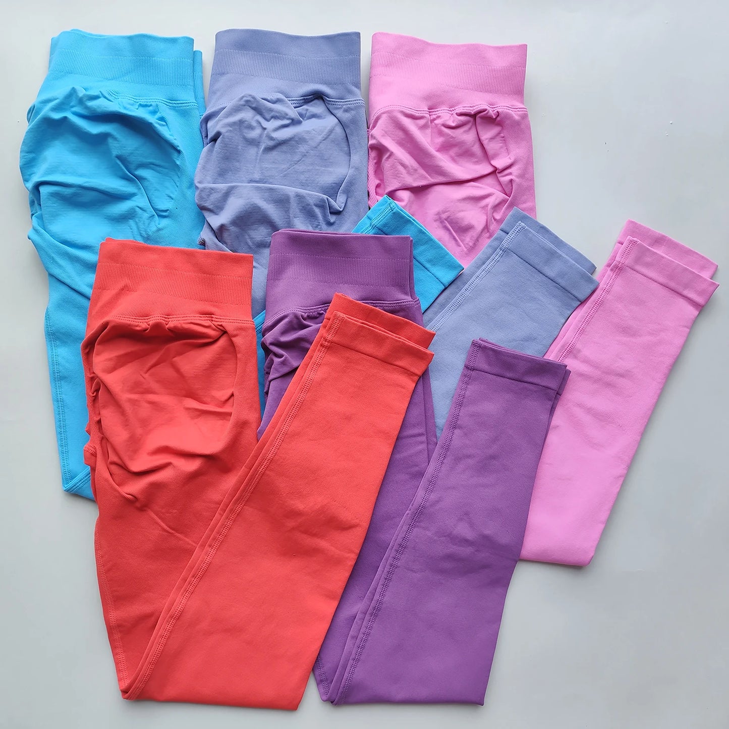 KiKis Woman Scrunch Bum Flare Leggings in blue purple pink red and lavender colors neatly folded