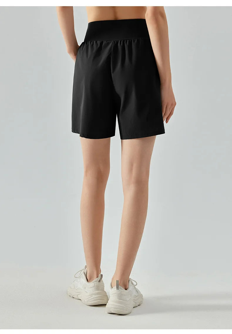 KiKis women's high waist running shorts in black with a wide waistband and relaxed fit