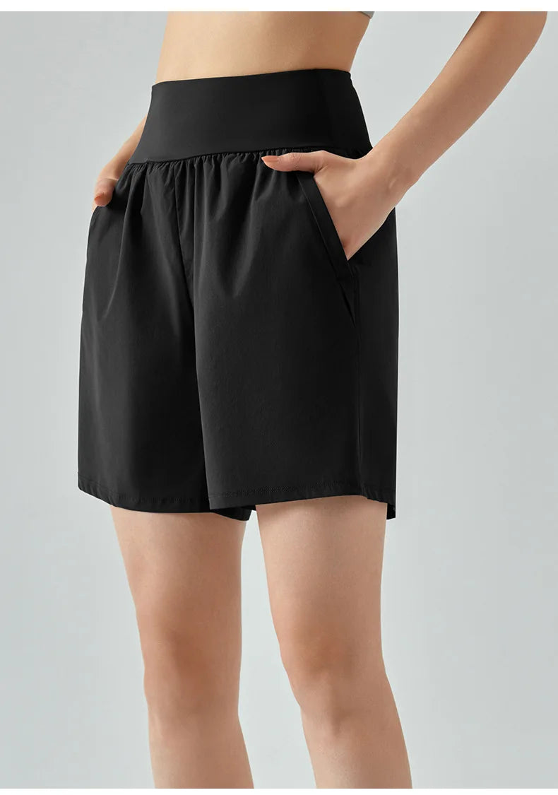 KiKis women's high waist running shorts in black with side pockets and comfortable elastic waistband