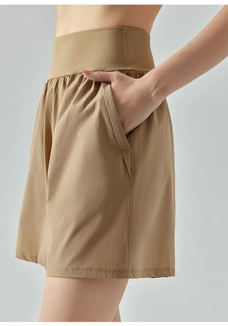 KiKis women's high waist running shorts in beige with elastic waistband and side pocket