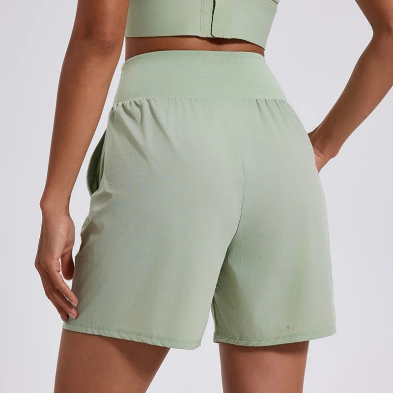 KiKis women's high waist running shorts in light green with a comfortable elastic waistband