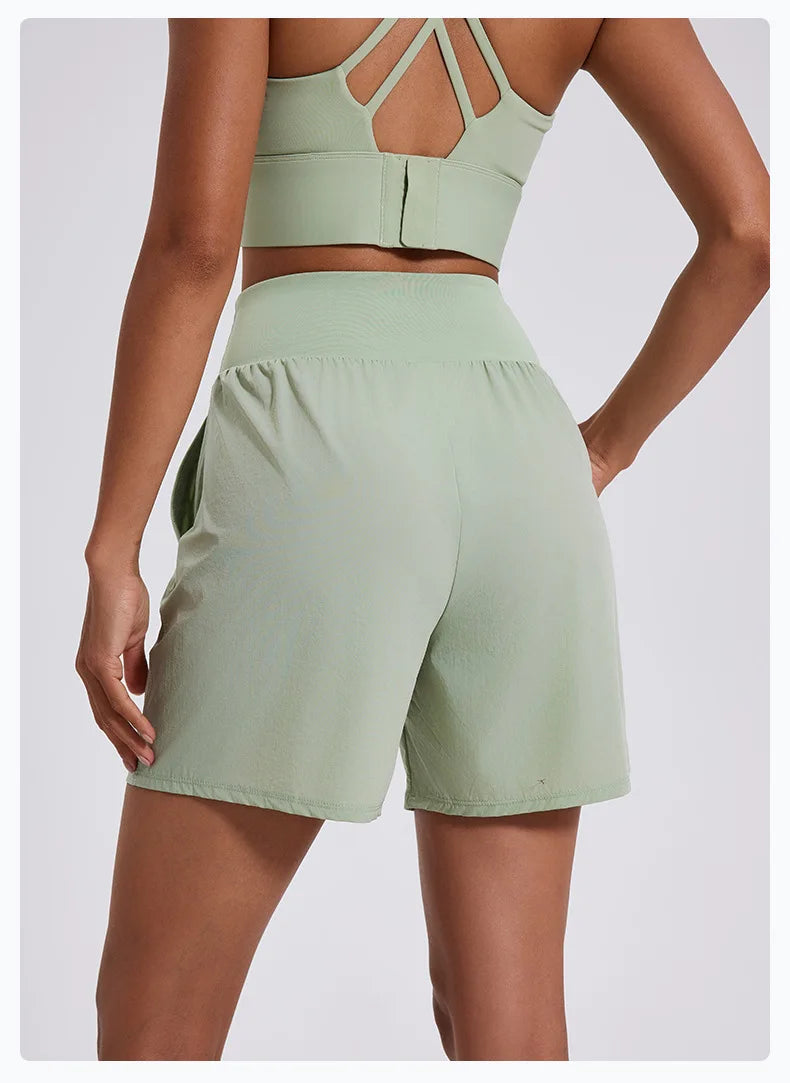 KiKis women's high waist running shorts in light green shown from the back with a comfortable waistband