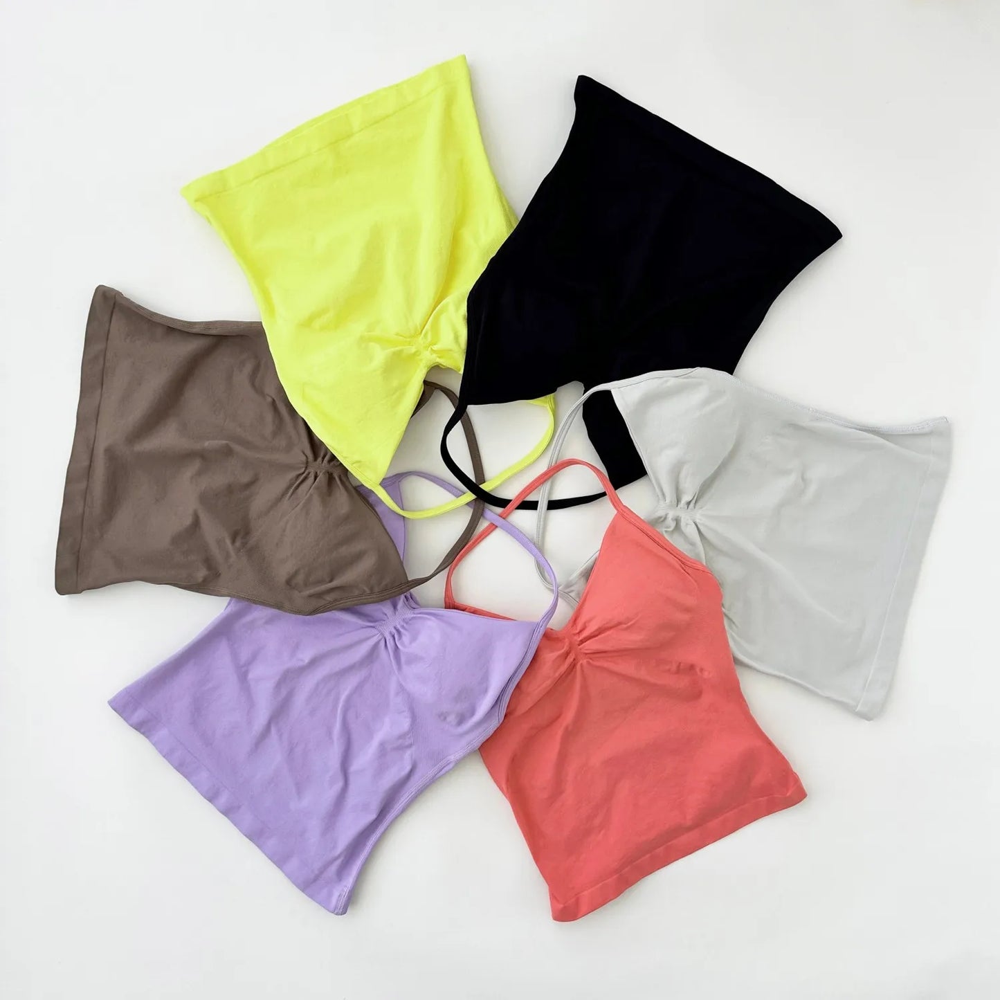 KiKis women's backless gym top collection in multiple colors including black, yellow, gray, coral, lavender, and brown