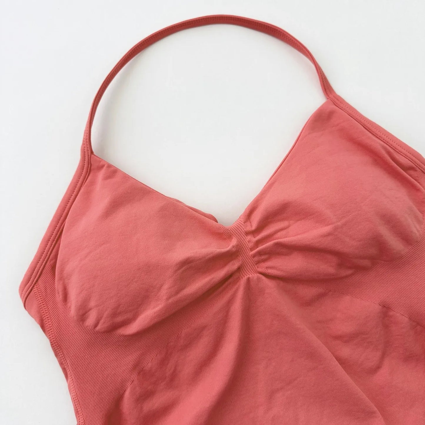 KiKis Women's Backless Gym Top in coral color with thin straps and ruched front design