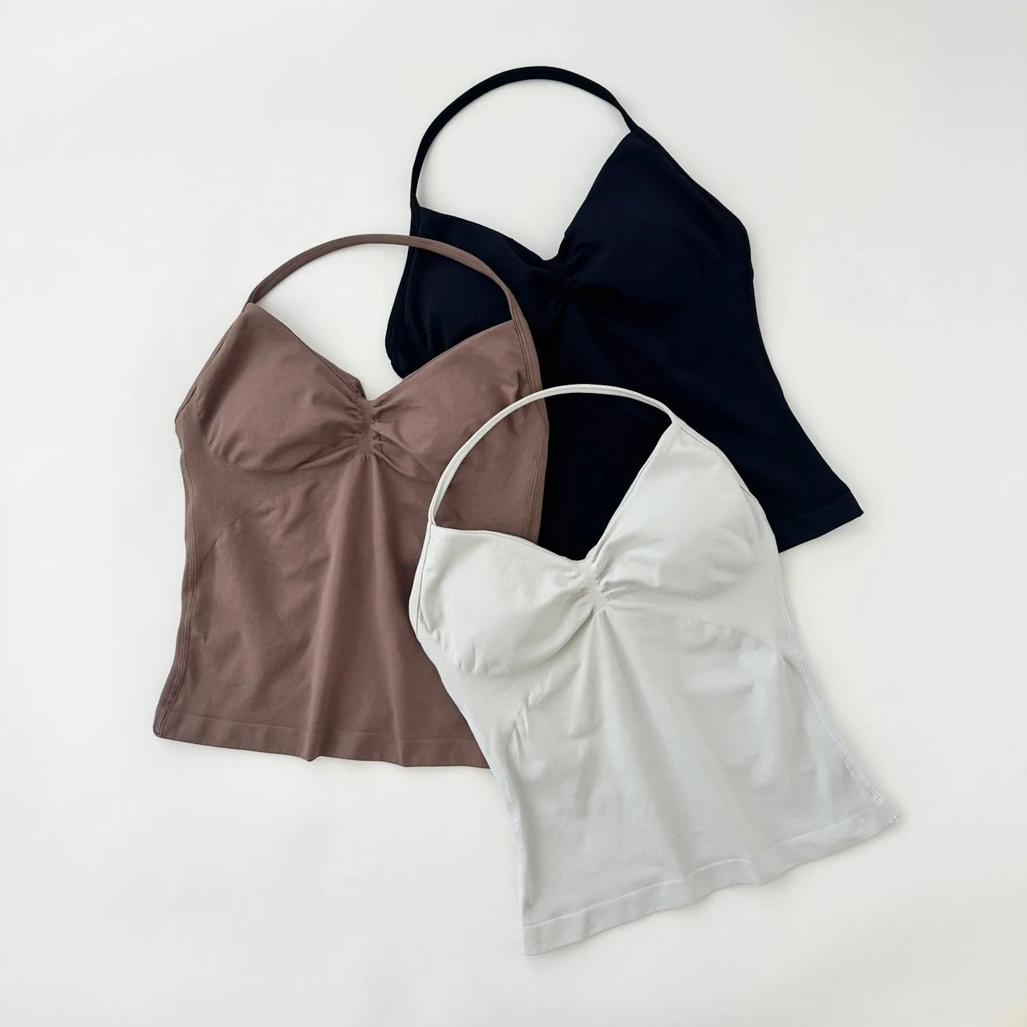 KiKis women's backless gym top set in black, brown, and white with ruched front design