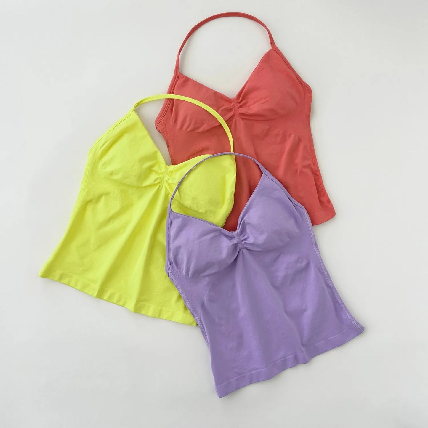 KiKis women's backless gym tops in coral, lime yellow, and lavender with spaghetti straps