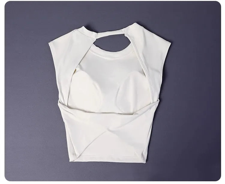 KiKis white women's backless sports tank top laid flat on gray surface