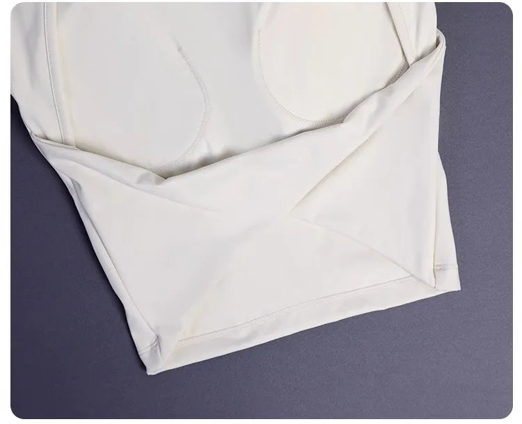 KiKis white women's backless sports tank top laid flat showing smooth fabric and stitching details