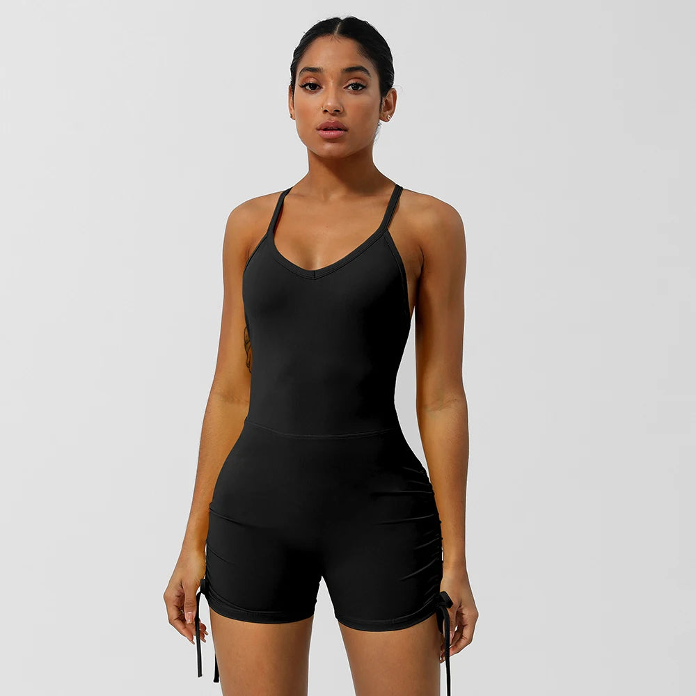 KiKis women's cross back yoga jumpsuit in black with adjustable straps and ruched shorts