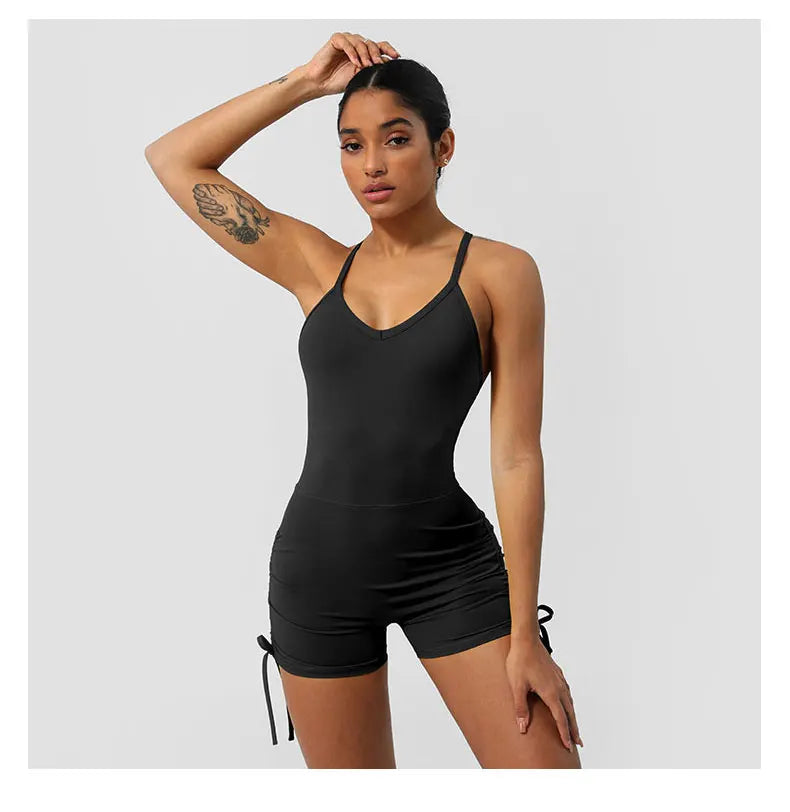 KiKis women's cross back yoga jumpsuit in black fitted design with adjustable side ties