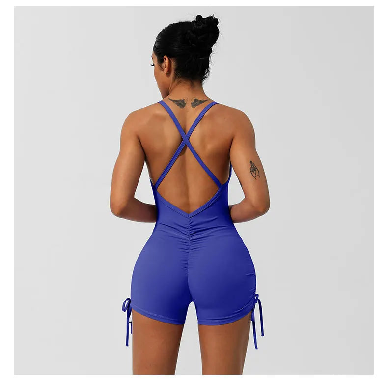 KiKis women's cross back yoga jumpsuit in blue with ruched detailing and adjustable side ties