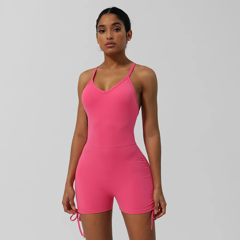 KiKis bright pink women's cross back yoga jumpsuit with adjustable straps and short length