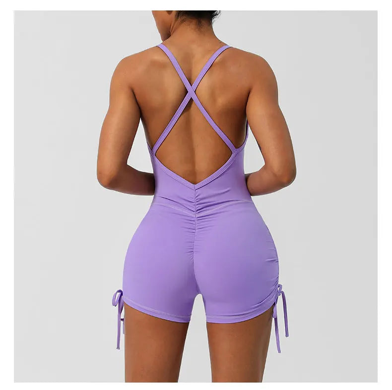 KiKis women's cross back yoga jumpsuit in lavender with adjustable side ties and ruched detail