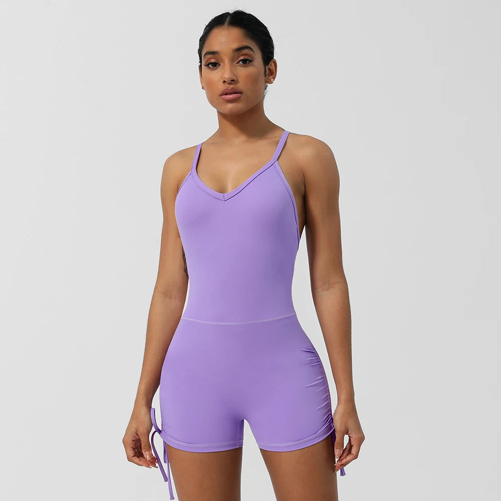 KiKis women's cross back yoga jumpsuit in lavender with adjustable side ties and fitted design