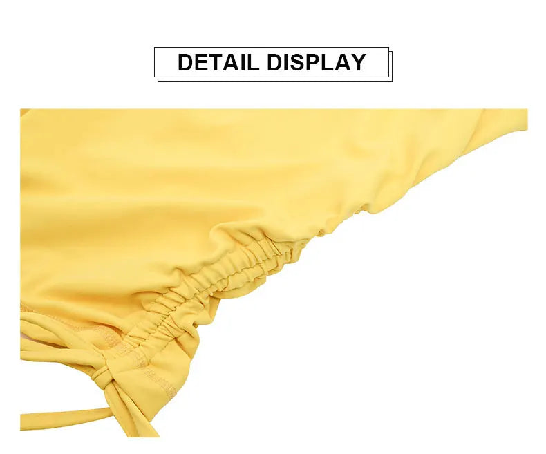 Detailed close-up of yellow fabric and stitching on women's cross back yoga jumpsuit by KiKis