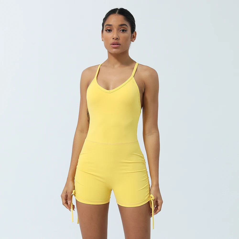 KiKis women's cross back yoga jumpsuit in yellow with adjustable side ties and fitted design