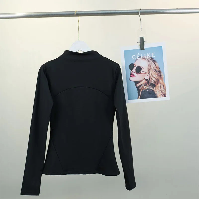 KiKis black women's fleece yoga jacket hanging on white hanger against plain background