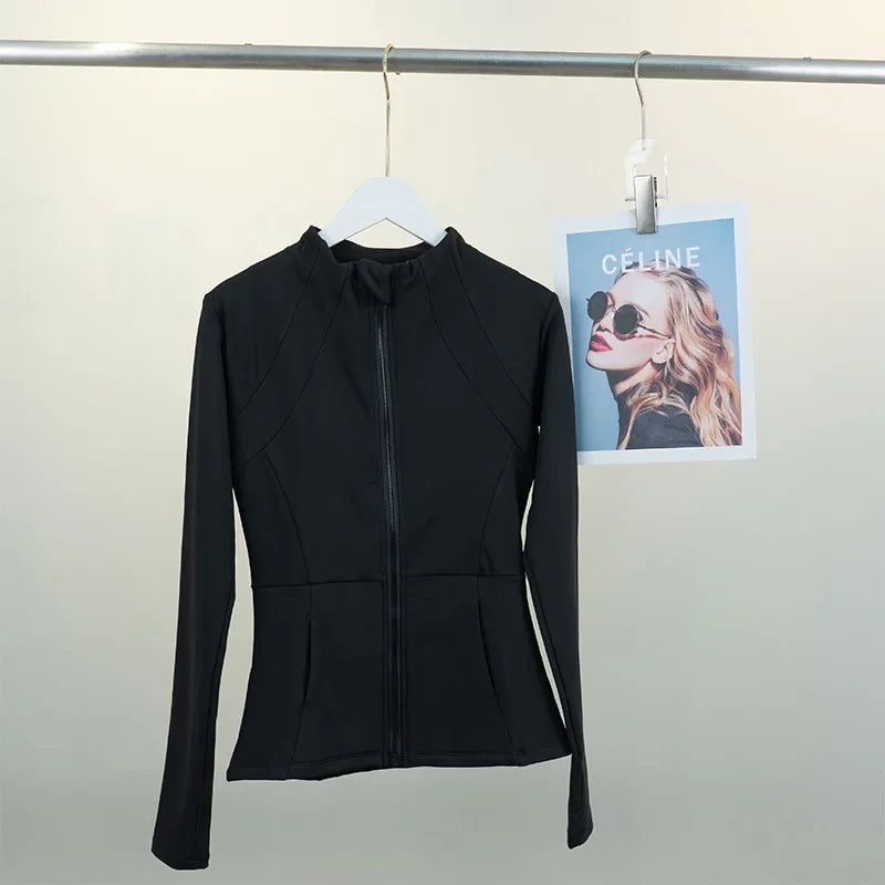 KiKis black women's fleece yoga jacket with full front zipper and fitted design hanging on white hanger