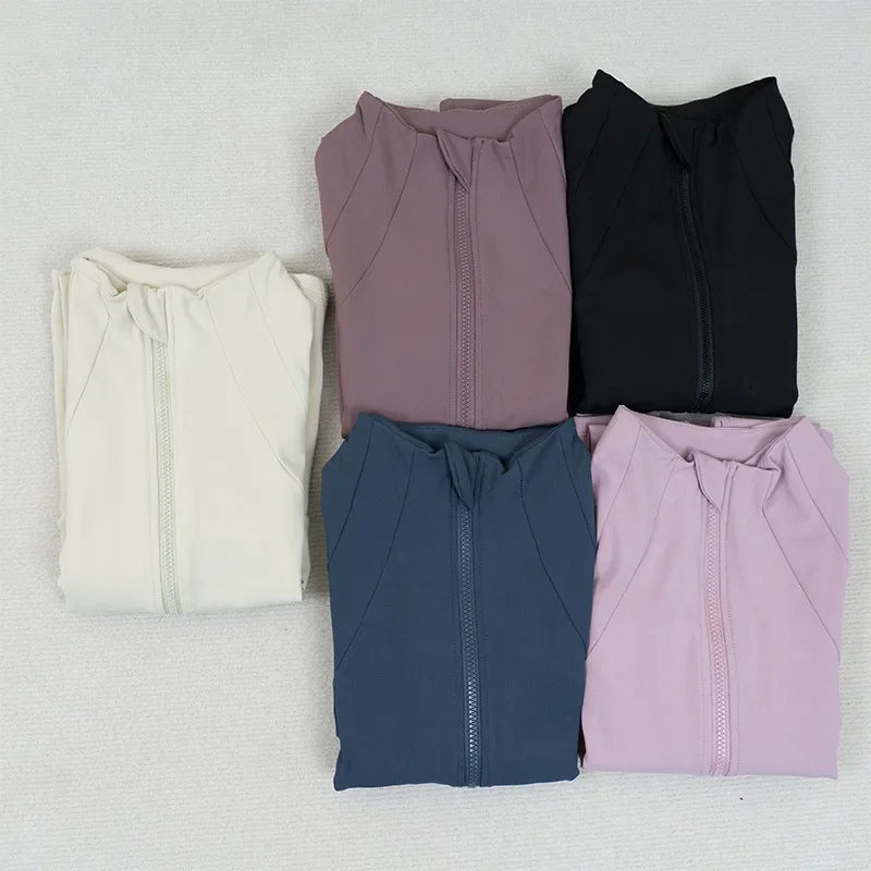 KiKis women's fleece yoga jackets folded in five colors including black, blue, cream, pink, and mauve