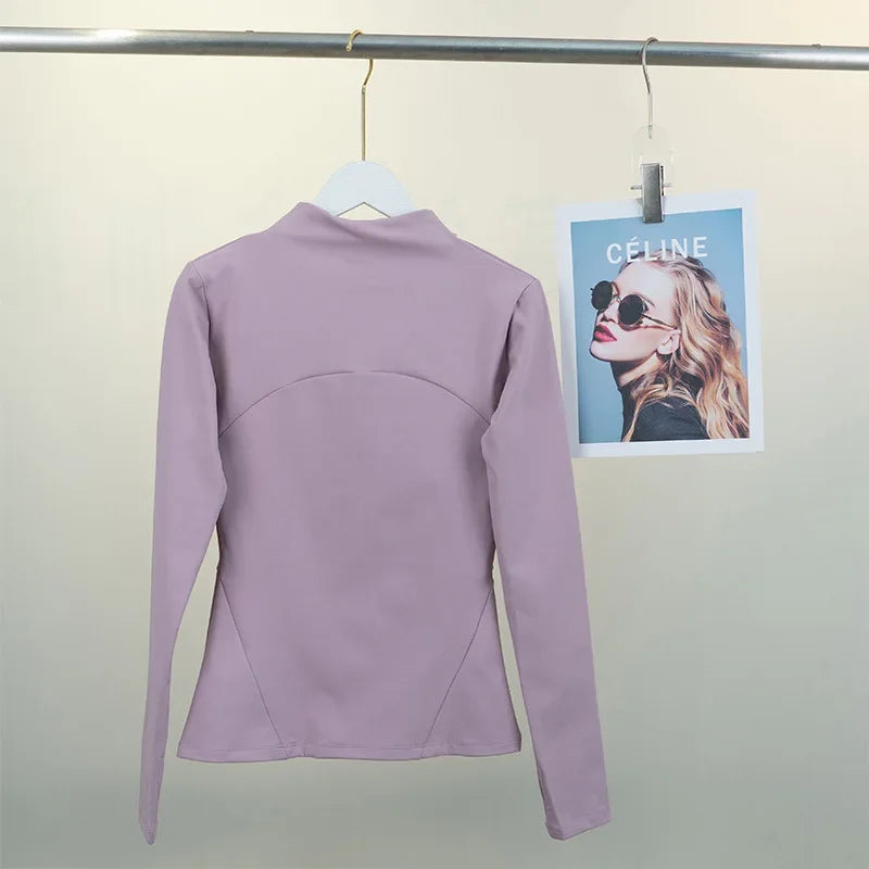 KiKis women's fleece yoga jacket in light purple hanging on a white hanger against a neutral background