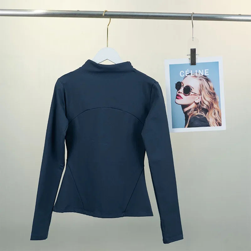 KiKis women's fleece yoga jacket in dark color hanging on white hanger against a light background