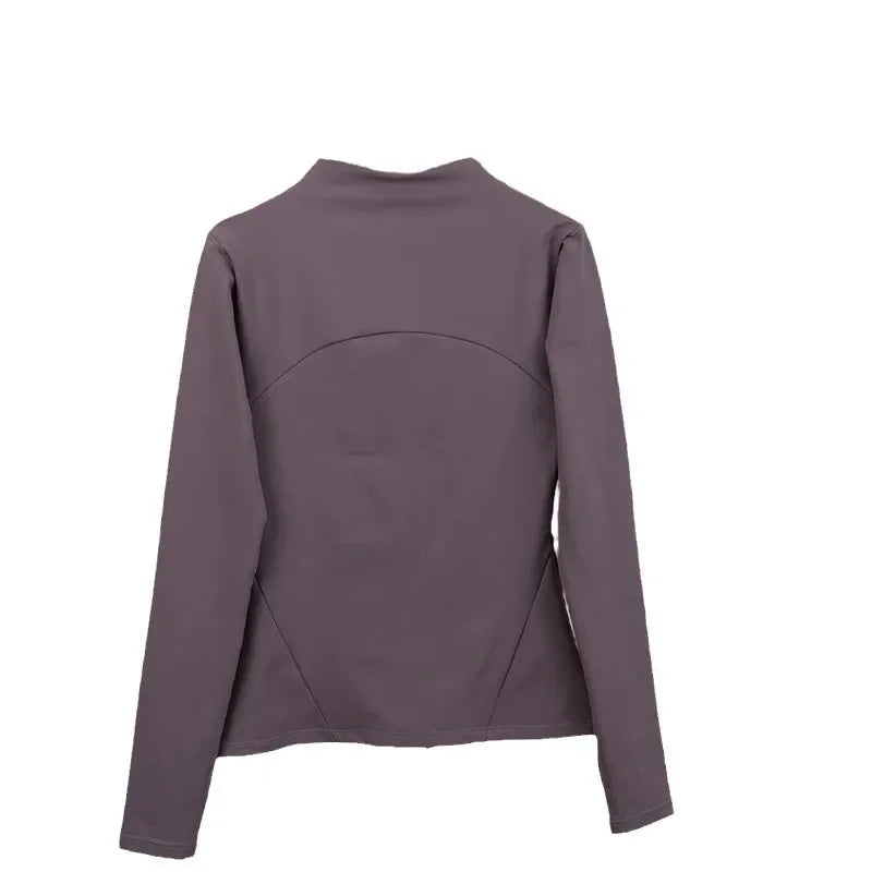 Back view of women's fleece yoga jacket in dark purple with long sleeves and fitted design