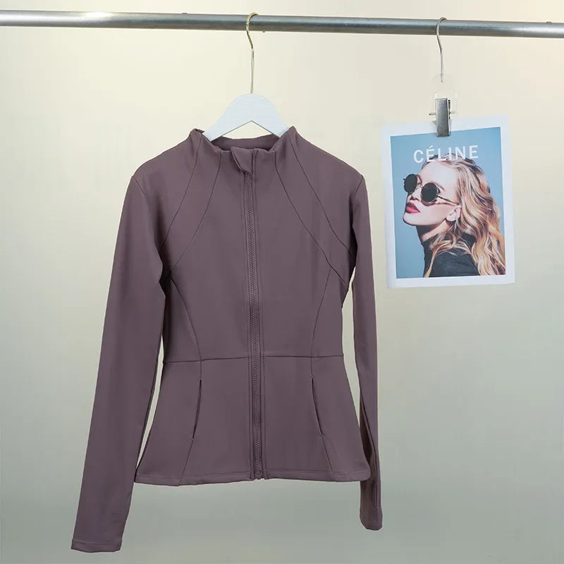 KiKis women's fleece yoga jacket in mauve with full zip and fitted design hanging on a hanger