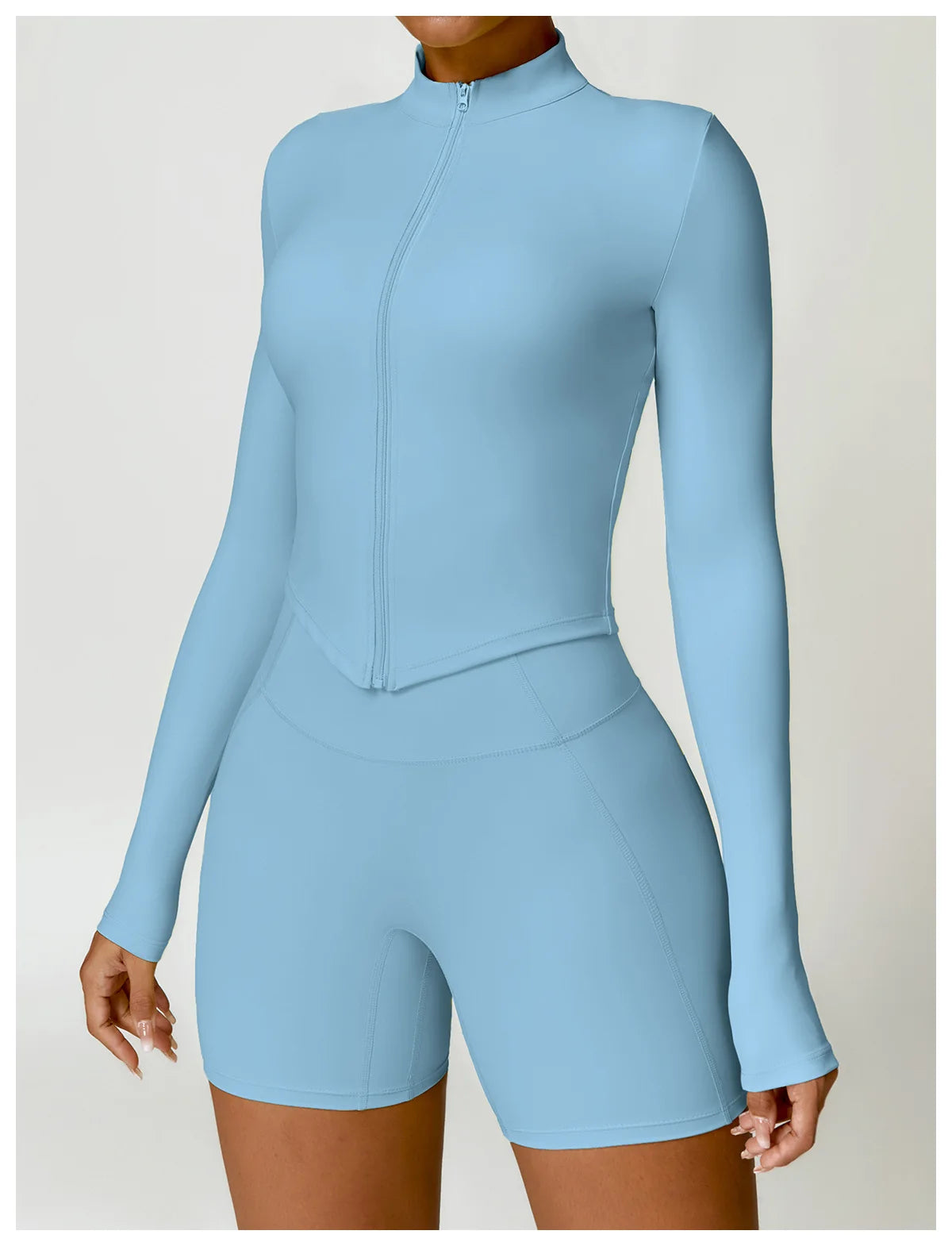 KiKis women's gym workout zip up top in light blue with long sleeves and high collar