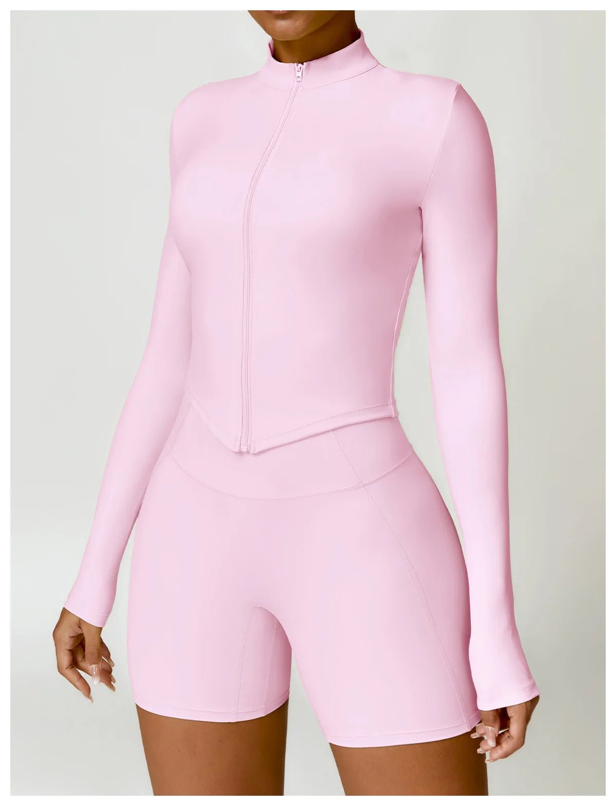 KiKis women's gym workout zip up top in light pink with long sleeves and high collar