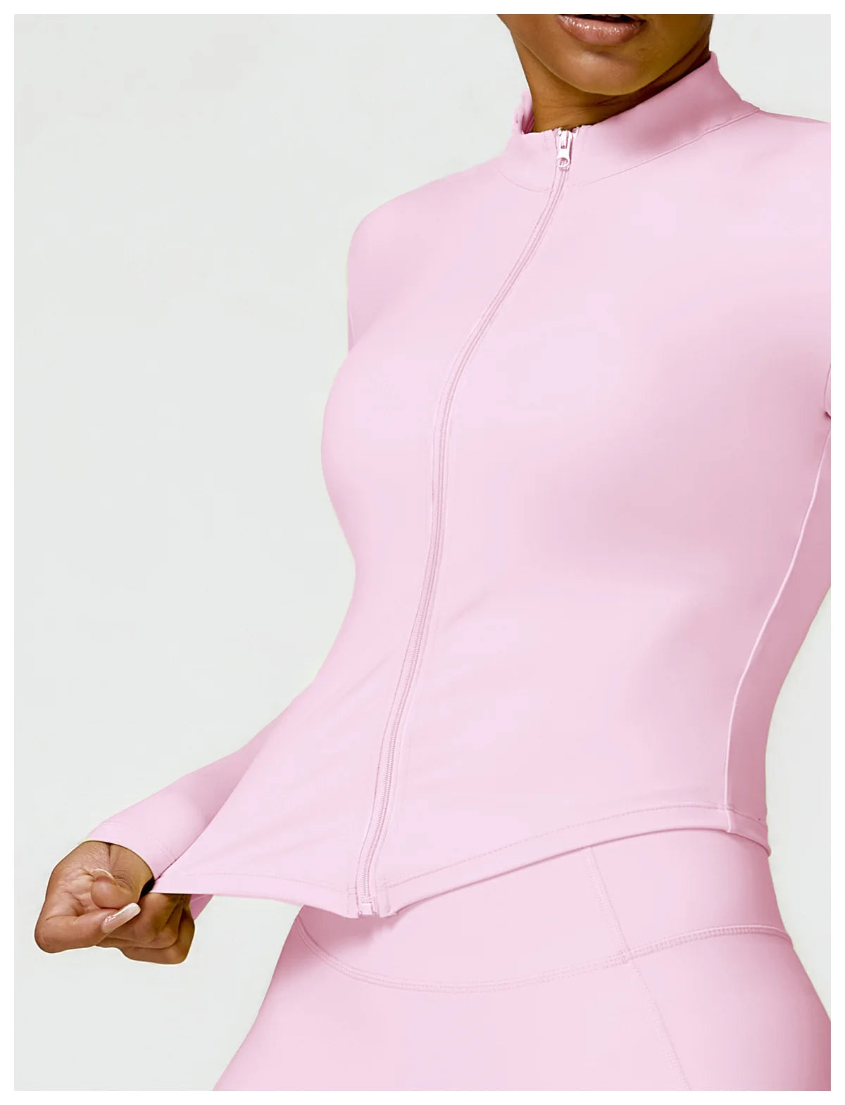 KiKis pastel pink women's gym workout zip up top with long sleeves and fitted design