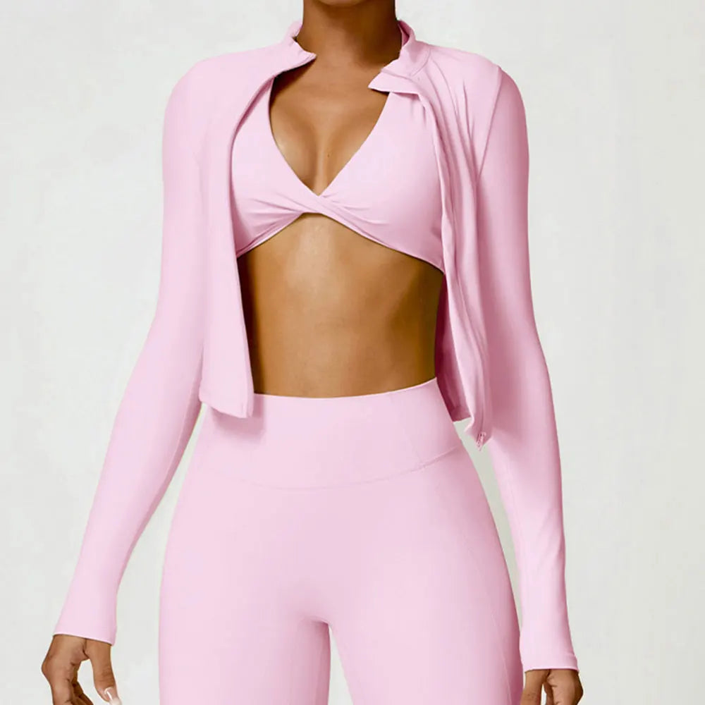 KiKis women's gym workout zip up top in light pink shown on a model with matching leggings