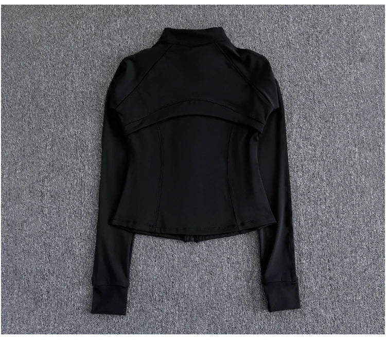 KiKis black women's high-end exercise jacket with long sleeves and high collar laid flat on gray surface