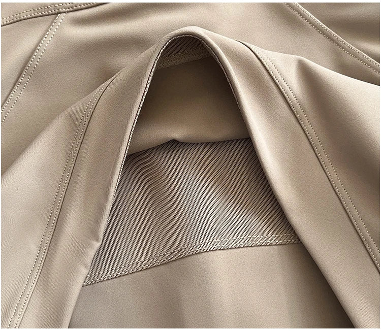 Close-up of beige fabric and stitching detail on a women's high-end exercise jacket by KiKis